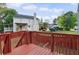 Two-story house with a wood deck overlooking a fenced backyard with some mature trees at 1647 Imperial Ct, Norcross, GA 30093