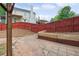 Spacious backyard with a red wooden fence and an area for a garden at 1647 Imperial Ct, Norcross, GA 30093