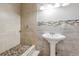 Bathroom with tile walls, tiled walk-in shower and pedestal sink at 1647 Imperial Ct, Norcross, GA 30093
