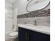 Updated bathroom featuring modern vanity, countertop, and stylish tiled backsplash at 1647 Imperial Ct, Norcross, GA 30093