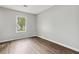 Bright bedroom with a window overlooking the outdoors and beautiful wood-look flooring at 1647 Imperial Ct, Norcross, GA 30093