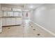 Basement kitchen features white cabinets, light countertops, and neutral tile flooring at 1647 Imperial Ct, Norcross, GA 30093