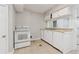 Cozy kitchen with white cabinets, sink, and a white electric range at 1647 Imperial Ct, Norcross, GA 30093