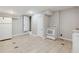 Basement kitchen includes white cabinets, sink, electric range and refrigerator at 1647 Imperial Ct, Norcross, GA 30093