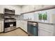 Renovated kitchen with stainless steel appliances and granite countertops provides style at 1647 Imperial Ct, Norcross, GA 30093