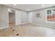 Open living space has light walls, neutral tile flooring, and an exterior window at 1647 Imperial Ct, Norcross, GA 30093