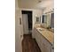 Bathroom featuring wood-look flooring, granite countertops, and a shower/tub combo at 173 Amherst Nw Pl, Atlanta, GA 30327
