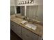 Bathroom with granite countertops, white cabinets, and modern lighting fixtures at 173 Amherst Nw Pl, Atlanta, GA 30327