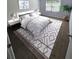 Bright bedroom with a decorative rug, large window, and neutral decor at 173 Amherst Nw Pl, Atlanta, GA 30327