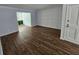 Spacious living room with hardwood floors and paneled accent wall with natural light at 173 Amherst Nw Pl, Atlanta, GA 30327