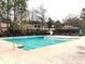 Large community pool surrounded by mature trees and residential buildings at 173 Amherst Nw Pl, Atlanta, GA 30327