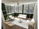 Cozy sunroom with lots of windows, stylish furniture, and decorative accent walls at 173 Amherst Nw Pl, Atlanta, GA 30327