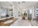 Bright bathroom features marble countertops, dual sinks, and a glass-enclosed shower with a soaking tub at 3114 Peachtree Ne Dr, Atlanta, GA 30305
