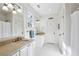 Clean bathroom featuring double sinks, white cabinets and bright lighting, a stylish and functional space at 3114 Peachtree Ne Dr, Atlanta, GA 30305