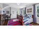 Cozy bedroom with a decorative area rug, a wood bed frame, and art on the wall, lit by natural light at 3114 Peachtree Ne Dr, Atlanta, GA 30305