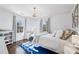 Comfortable bedroom featuring hardwood floors, natural light, and a stylish blue rug, ideal for relaxation at 3114 Peachtree Ne Dr, Atlanta, GA 30305