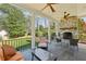 Relaxing covered porch featuring a stone fireplace, ceiling fans, and outdoor seating at 3114 Peachtree Ne Dr, Atlanta, GA 30305