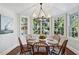 Charming dining area featuring a round table, built-in shelving, and large windows at 3114 Peachtree Ne Dr, Atlanta, GA 30305