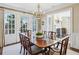 Elegant dining room boasting a chandelier, french doors, and a table set for six, perfect for entertaining at 3114 Peachtree Ne Dr, Atlanta, GA 30305