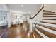 Open foyer featuring hardwood floors, staircase with wood treads, and sitting area with modern chairs at 3114 Peachtree Ne Dr, Atlanta, GA 30305