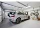 Clean, organized garage with epoxy floor, storage, and space for multiple vehicles and a bicycle at 3114 Peachtree Ne Dr, Atlanta, GA 30305