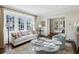 Cozy living room with large windows and a view into another living area at 3114 Peachtree Ne Dr, Atlanta, GA 30305