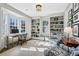Bright home office featuring custom built-ins, a bay window, and comfortable seating area with patterned armchairs at 3114 Peachtree Ne Dr, Atlanta, GA 30305