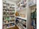 Well-organized walk-in pantry with shelving, storage containers, and wood flooring for ample storage at 3114 Peachtree Ne Dr, Atlanta, GA 30305