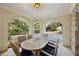 Covered outdoor patio with brick arches, wood dining table, and views of the surrounding landscape at 3114 Peachtree Ne Dr, Atlanta, GA 30305