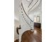 Elegant curved staircase with wood floors and white railings, leading to the upper level at 3114 Peachtree Ne Dr, Atlanta, GA 30305