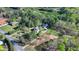 Aerial shot of property and home with separate garage surrounded by lush trees, landscaping and nature at 3211 Thompson Mill Rd, Buford, GA 30519