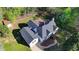 Aerial view showcasing the roof, large lot and deck with treeline at 3211 Thompson Mill Rd, Buford, GA 30519
