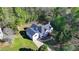 Aerial view of the home showing a large deck and treelined lot at 3211 Thompson Mill Rd, Buford, GA 30519
