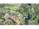 Aerial view of property with home, winding driveway, surrounded by mature trees and landscaping at 3211 Thompson Mill Rd, Buford, GA 30519