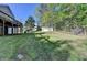 Landscaped backyard with mature trees and detached garage at 3211 Thompson Mill Rd, Buford, GA 30519