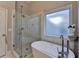 This modern bathroom features a walk-in shower and a soaking tub at 3211 Thompson Mill Rd, Buford, GA 30519