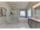 Bathroom showcasing a walk-in glass shower, a soaking tub, and a modern vanity at 3211 Thompson Mill Rd, Buford, GA 30519