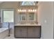 Bathroom featuring a double vanity, modern fixtures, and a large window for natural light at 3211 Thompson Mill Rd, Buford, GA 30519