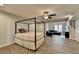 Bedroom with gray walls, hardwood flooring, ceiling fan and a canopy bed and living area at 3211 Thompson Mill Rd, Buford, GA 30519