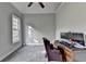 Bedroom with a large window and an office setup, bathed in soft, natural light with gray walls at 3211 Thompson Mill Rd, Buford, GA 30519
