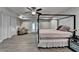 Bedroom with gray walls, hardwood flooring, ceiling fan and a canopy bed and French doors at 3211 Thompson Mill Rd, Buford, GA 30519