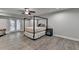 Bedroom with gray walls, hardwood flooring, ceiling fan and a canopy bed at 3211 Thompson Mill Rd, Buford, GA 30519