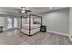 Bedroom with gray walls, hardwood flooring, ceiling fan and a canopy bed at 3211 Thompson Mill Rd, Buford, GA 30519
