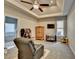 Spacious bedroom features a tray ceiling, ceiling fan, and an ensuite bathroom at 3211 Thompson Mill Rd, Buford, GA 30519