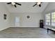 Large vaulted bonus room with plank floors, bright natural light from several windows, and arcade games at 3211 Thompson Mill Rd, Buford, GA 30519