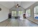 Vaulted bonus room with plank floors, large windows, filled with natural light and arcade games at 3211 Thompson Mill Rd, Buford, GA 30519