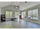 Spacious bonus room with high ceilings, plank flooring, and lots of natural light from large windows at 3211 Thompson Mill Rd, Buford, GA 30519