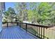 Wood deck overlooking the landscaped backyard with lush trees and a shed at 3211 Thompson Mill Rd, Buford, GA 30519