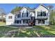 Charming two-story home with light siding, dark shutters, front yard and an attached garage at 3211 Thompson Mill Rd, Buford, GA 30519