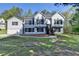 Charming two-story home with light siding, dark shutters, front yard and an attached garage at 3211 Thompson Mill Rd, Buford, GA 30519